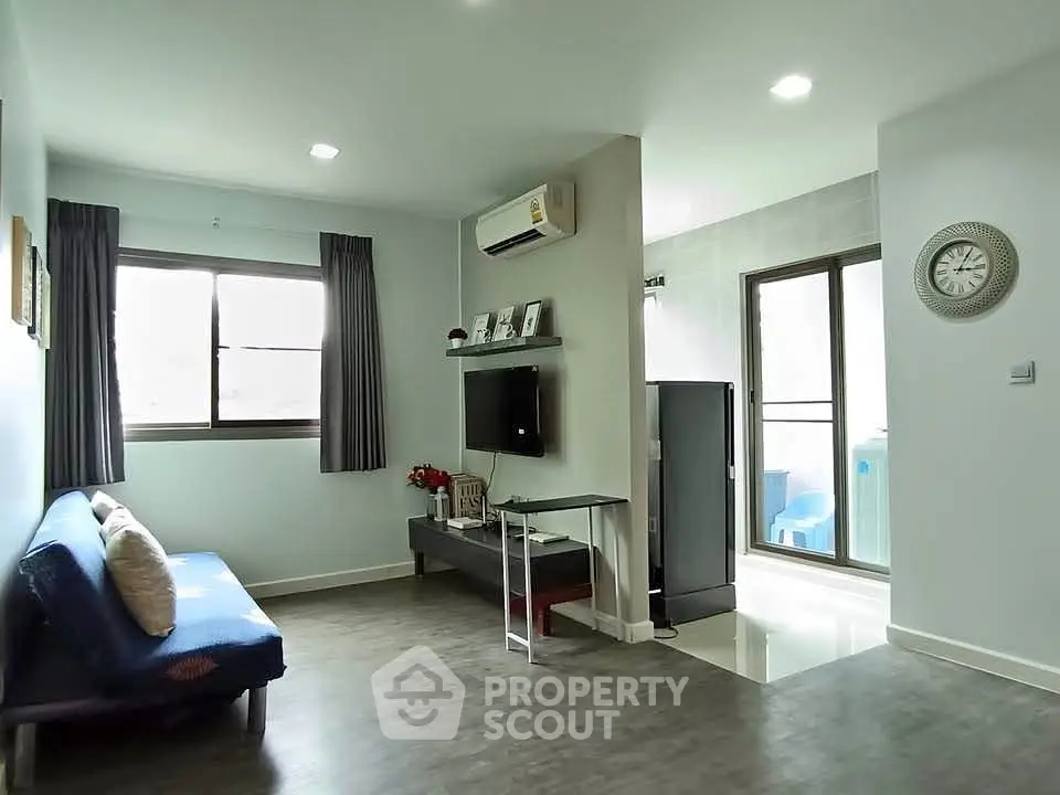 Modern living room with air conditioning and balcony access