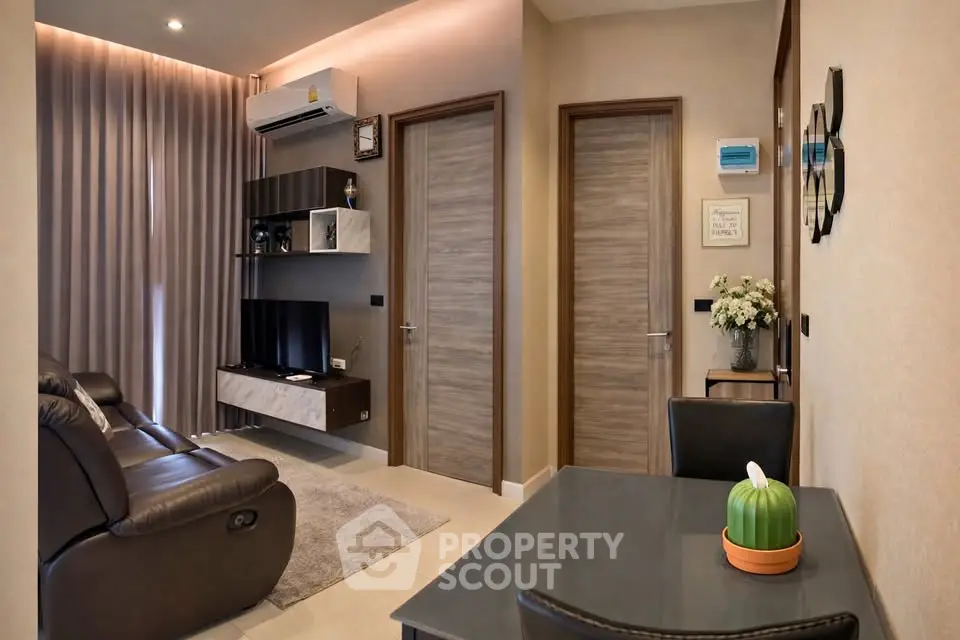 Modern living room with sleek furniture and wall-mounted TV