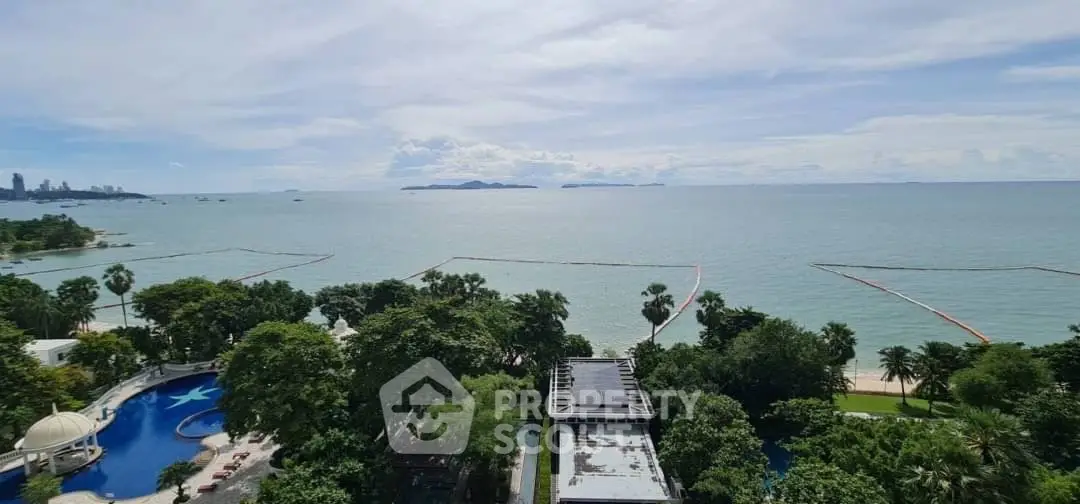 Stunning ocean view from high-rise building with lush greenery and poolside amenities.