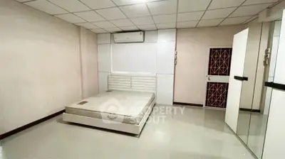 Spacious bedroom with modern design and ample storage in a prime real estate location.
