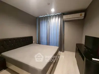 Modern bedroom with sleek design and air conditioning in a stylish apartment.