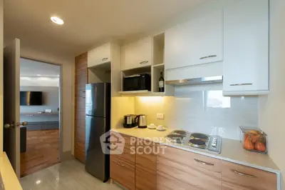 Modern kitchen with sleek cabinets and stainless steel appliances in a stylish apartment.