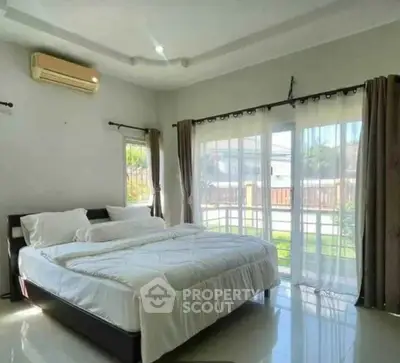 Bright and airy bedroom with large windows and modern decor