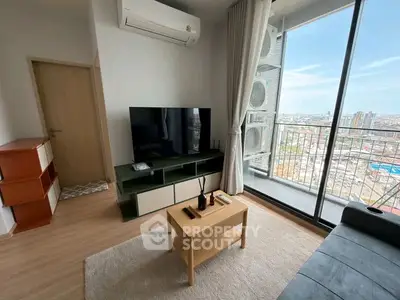 Modern living room with balcony view, stylish furniture, and air conditioning in a high-rise apartment.