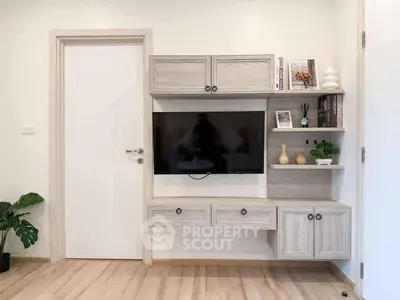 Modern living room with stylish TV cabinet and wooden flooring