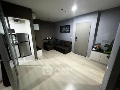 Modern apartment living room with sleek design and open kitchen layout