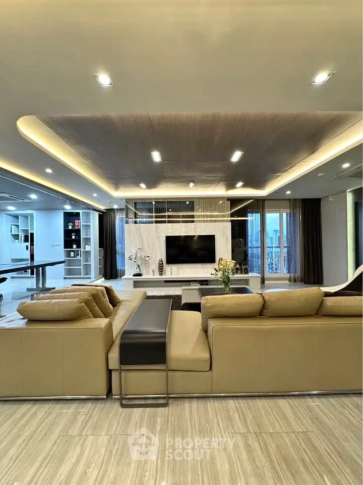 Luxurious modern living room with elegant lighting and spacious seating area.