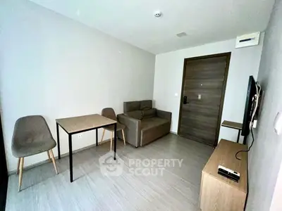 Modern minimalist living room with compact furniture and neutral tones