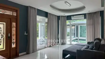 Spacious living room with pool view and modern decor