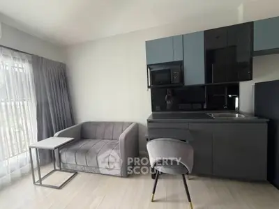 Modern compact living room with sleek kitchenette and stylish furniture
