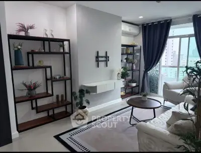 Stylish living room with modern decor and large window offering city views