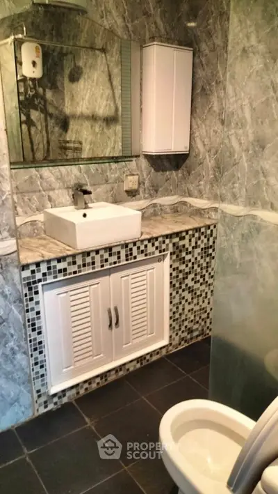 Modern bathroom with stylish sink and tiled walls