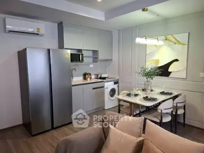 Modern kitchen with sleek appliances and dining area in stylish apartment