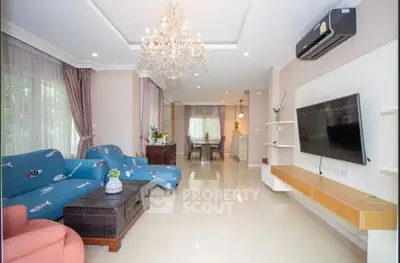 Spacious living room with elegant chandelier and modern decor