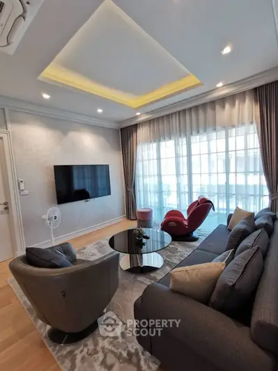 Luxurious modern living room with stylish furniture and large windows for natural light.