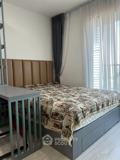 Cozy bedroom with modern decor and large window for natural light