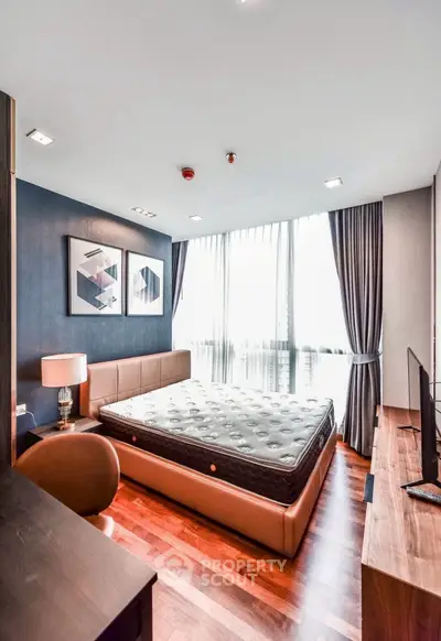 Luxurious bedroom with modern decor and large windows in a high-end apartment.