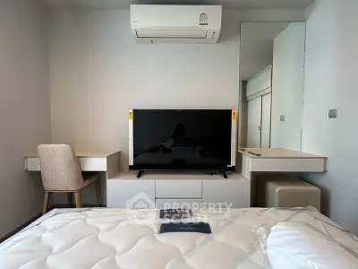 Modern bedroom with air conditioning, TV, and stylish furniture