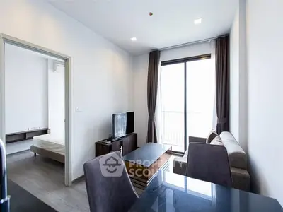 Modern living room with natural light and balcony access in a stylish apartment.