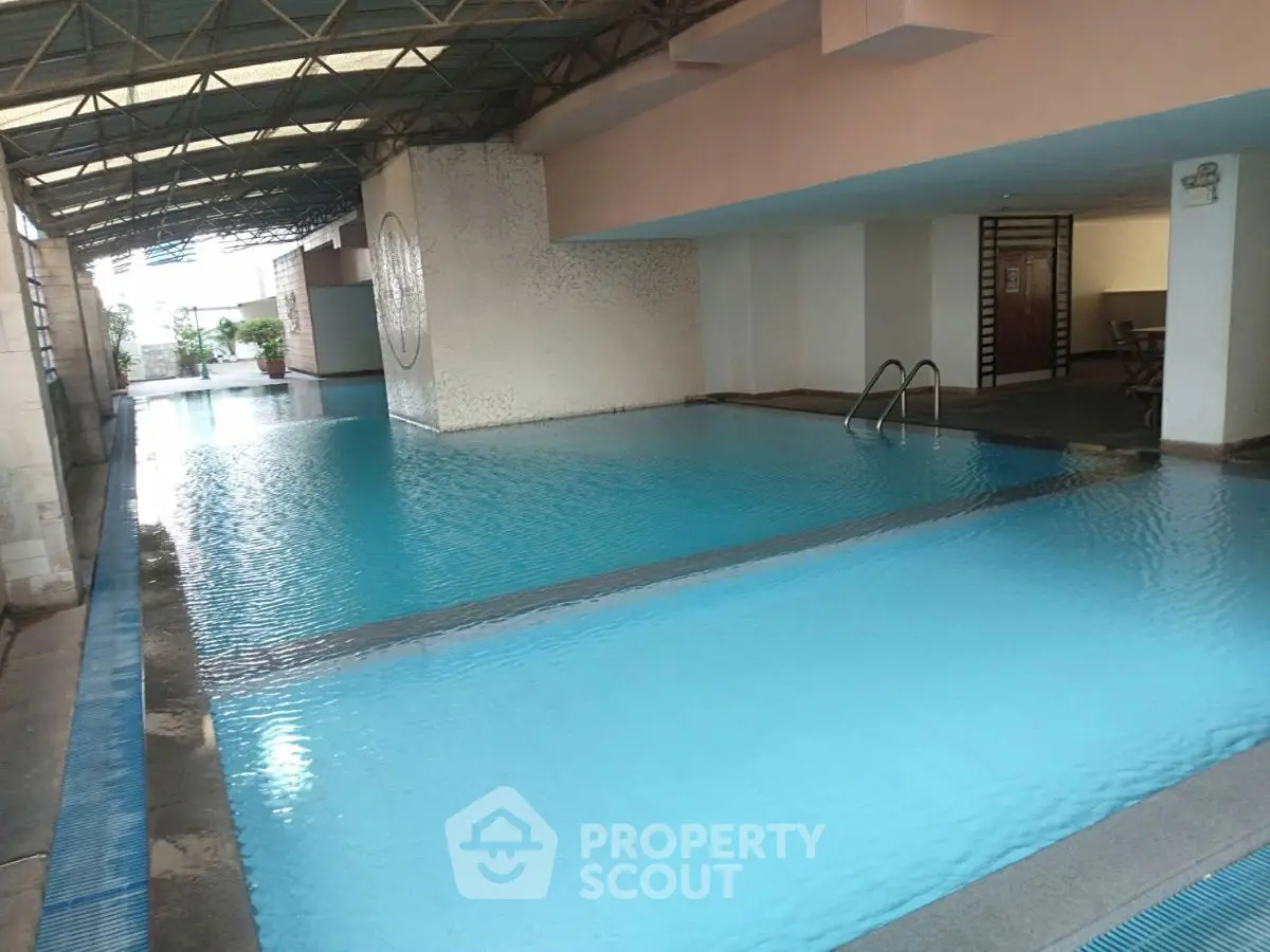 Luxurious indoor swimming pool with modern design and ample natural light.