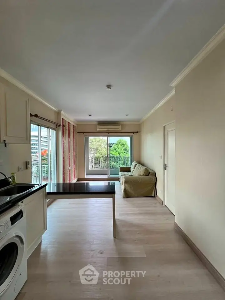 Spacious living room with modern decor and large windows offering a scenic view.