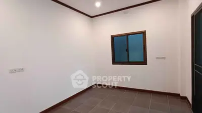 Minimalist empty room with tiled floor and window, ready for customization.