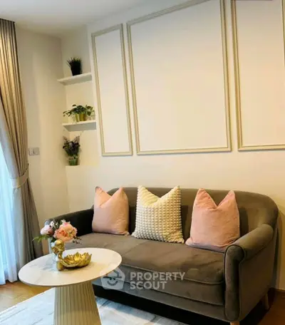 Chic living room with elegant sofa, stylish decor, and natural light for a cozy ambiance.