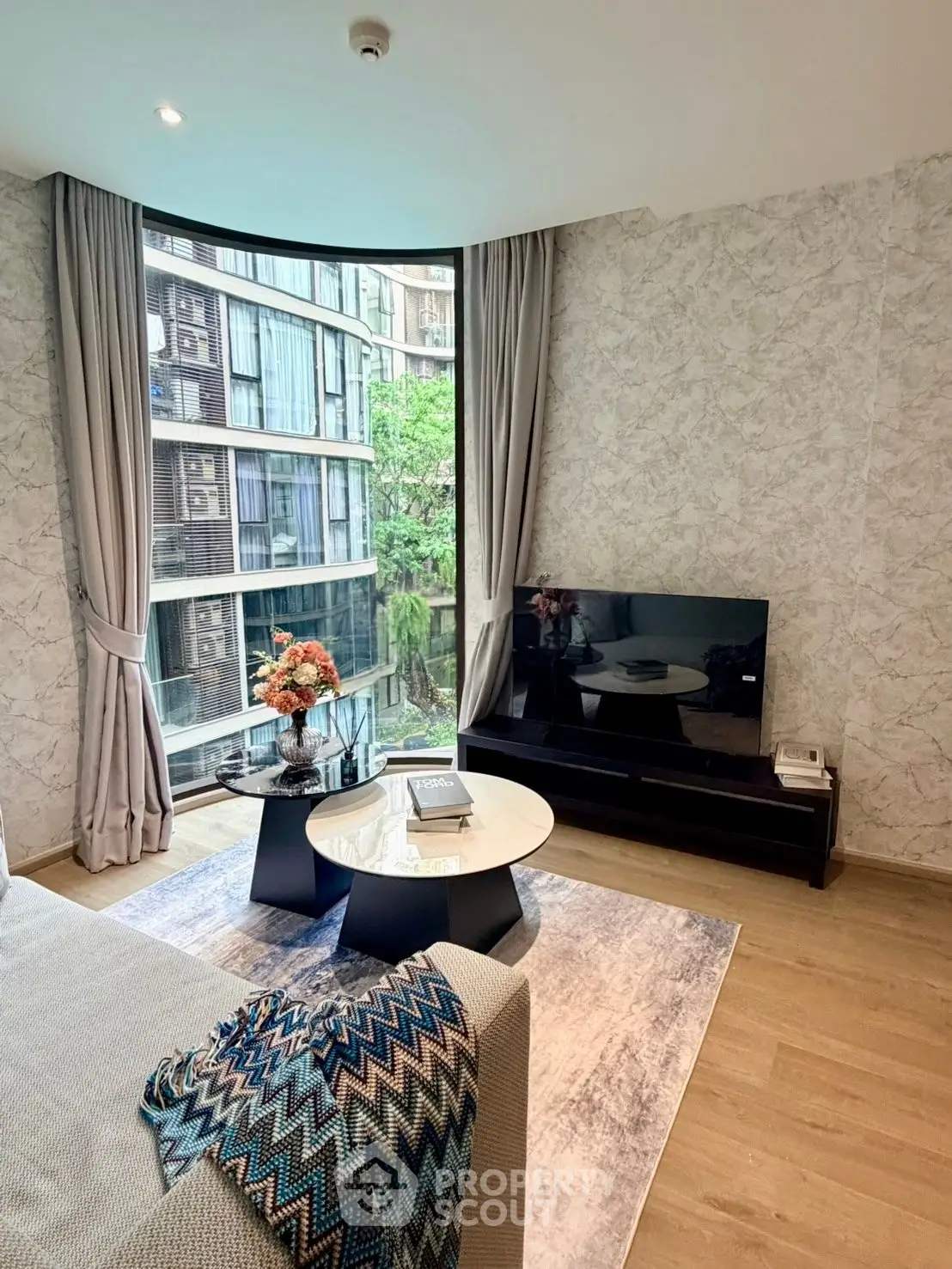 Modern living room with stylish decor and large window view in luxury apartment