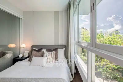 Bright and cozy bedroom with large windows and modern decor