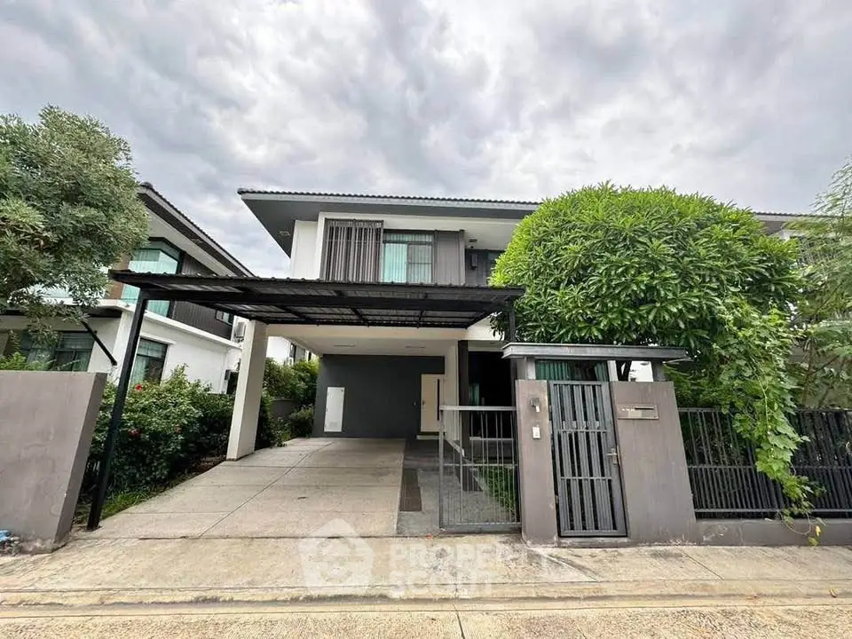 Modern two-story house with sleek design and spacious driveway in a serene neighborhood.