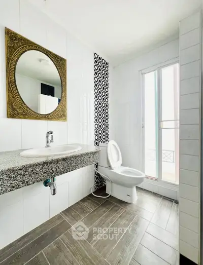 Modern bathroom with elegant mirror and natural light