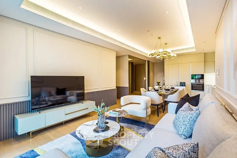 Luxurious modern living room with elegant decor and open dining area, featuring stylish furniture and ambient lighting.