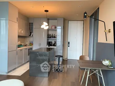 Modern kitchen with sleek cabinetry and stylish island in open layout apartment