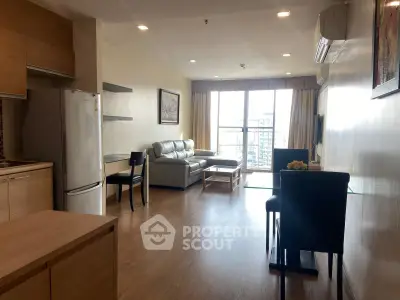 Spacious modern living room with open kitchen and city view