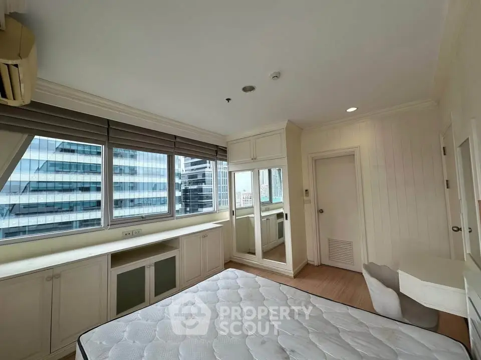 Spacious bedroom with city view and ample natural light