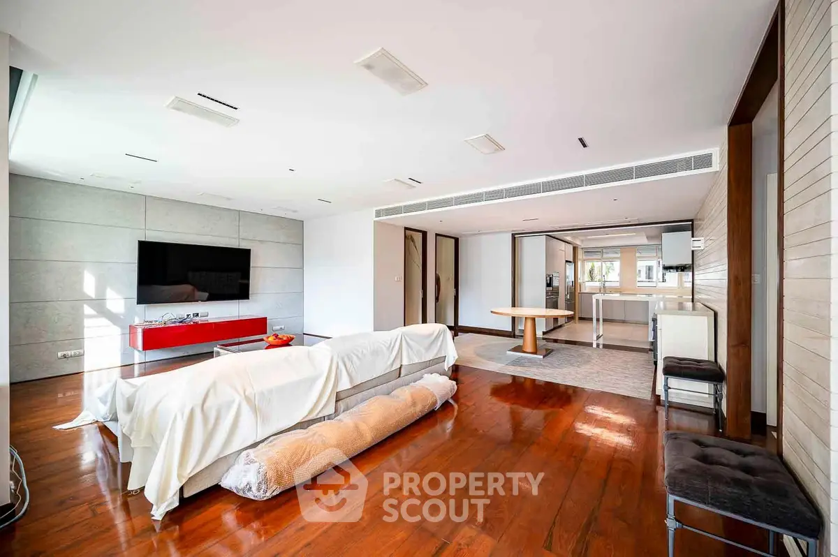 Spacious modern living room with open layout and sleek wooden flooring