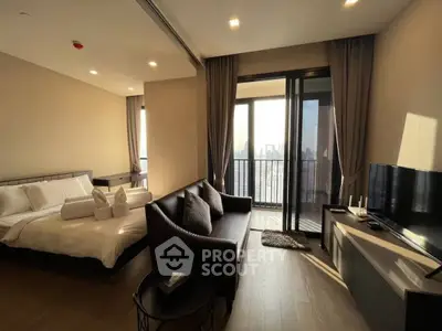Modern bedroom with balcony offering stunning city views, featuring elegant furnishings and natural light.