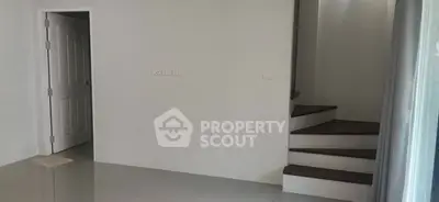 Minimalist interior with staircase and open door in modern home