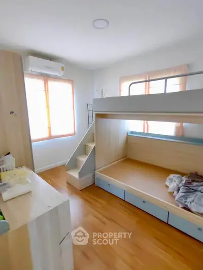Bright and cozy bedroom with bunk bed and wooden flooring
