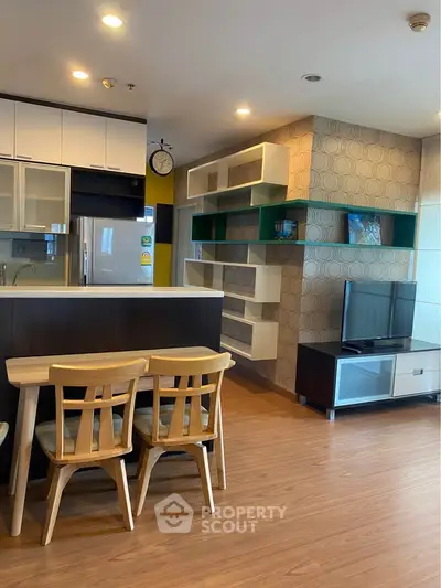 Modern living room with stylish open kitchen and wooden flooring