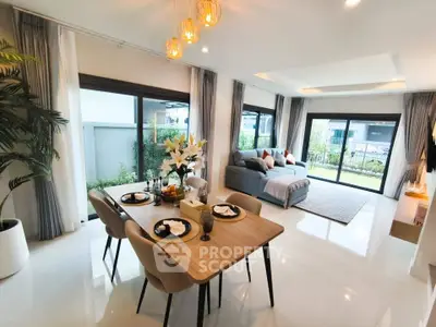 Spacious modern living room with elegant dining area and garden view.