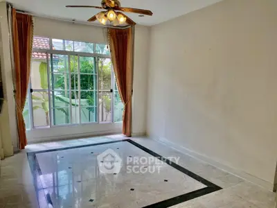Spacious empty room with large window and elegant floor design