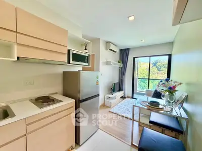 Modern open-layout kitchen and living room with balcony view in a stylish apartment.