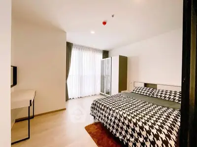 Spacious modern bedroom with stylish decor and ample natural light