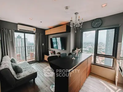Modern living room with city view, featuring sleek furniture and large windows for natural light.