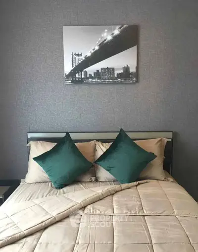 Cozy bedroom with stylish decor and elegant bedding, featuring a modern art piece above the bed.