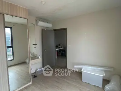 Spacious bedroom with modern air conditioning and large mirror closet