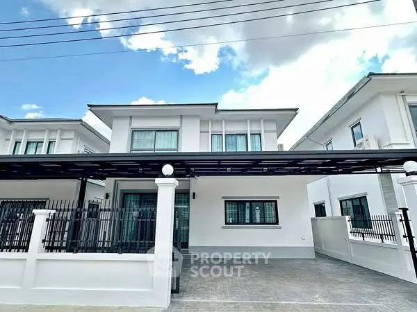 Modern two-story house with spacious driveway and sleek design