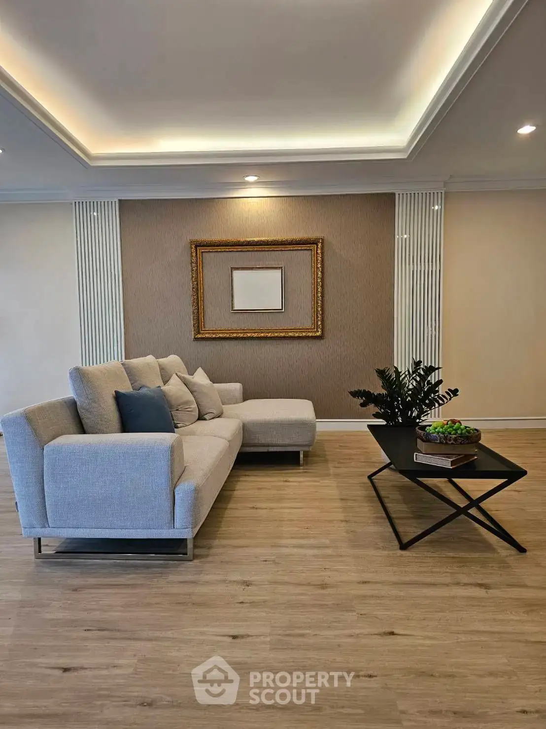 Elegant living room with modern sofa and stylish decor in a luxurious apartment.