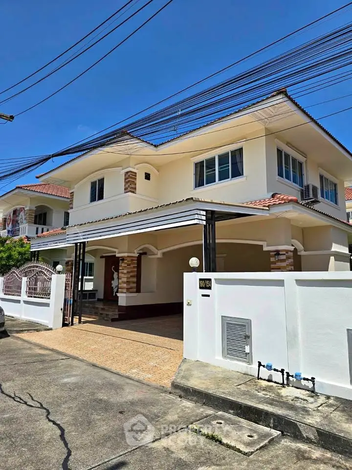 Charming two-story house with a spacious driveway and modern exterior design in a serene neighborhood.